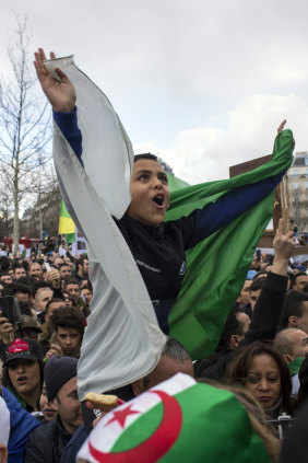 A boy wrapped in an Algerian flag protests against Bouteflika's rule in Paris, France in March. 