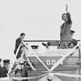 Amy Johnson waving to the crowds from the back of a car, Sydney, 1930.