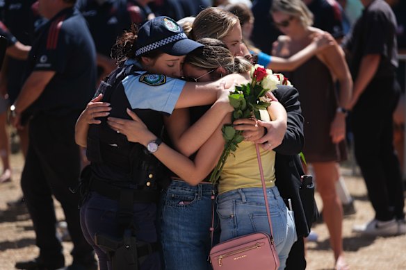 Mourners embrace at the Bondi memorial.