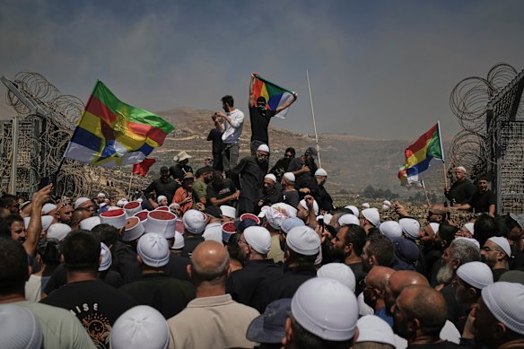 Druze from Syria and Israel protest on the Israeli-Syrian border amid clashes between Syrian government forces and Druze armed groups in Sweida in July.
