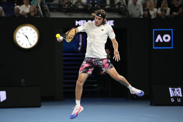 Stefanos Tsitsipas returns the ball to Jannik Sinner.