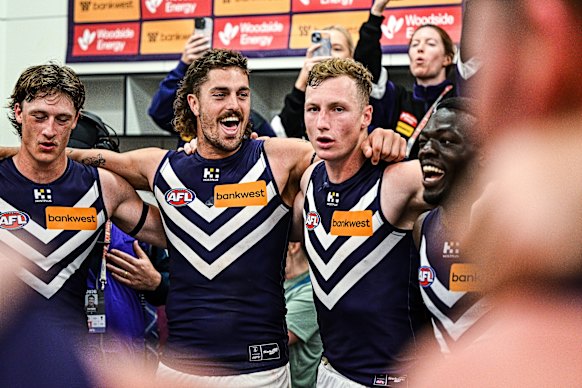Luke Jackson, Jye Amiss and Josh Treacy sing the Fremantle song after the win on Saturday.
