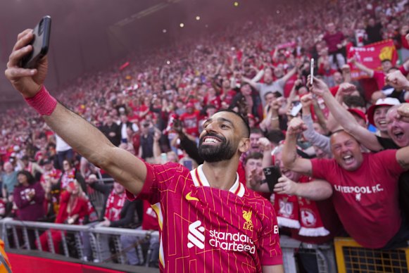Liverpool’s Mohamed Salah celebrates by taking a selfie after the team won the English Premier League.