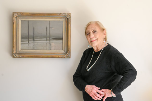 Art historian Rosalind Hollinrake with Clarice Beckett’s painting Wet Night, Brighton.