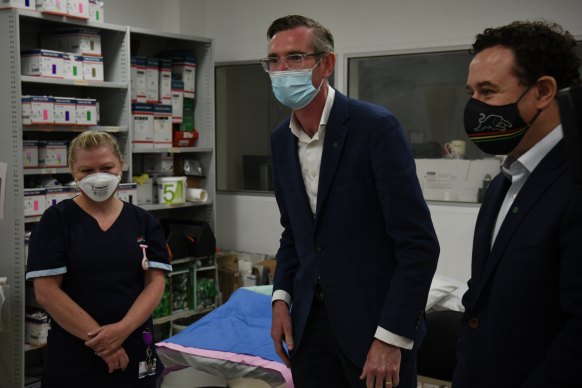 NSW Premier Dominic Perrottet talks with health workers at Nepean Hospital in Sydney on Sunday.