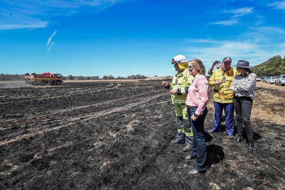 Premier Jacinta Allan (front left) and Emergency Services Minister Jaclyn Symes (right) survey fire damage with emergency personnel on Thursday.