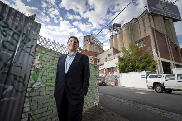 Joe Russo, in better days before the company collapse, in front of the Nylex site on Melbourne’s Yarra river.