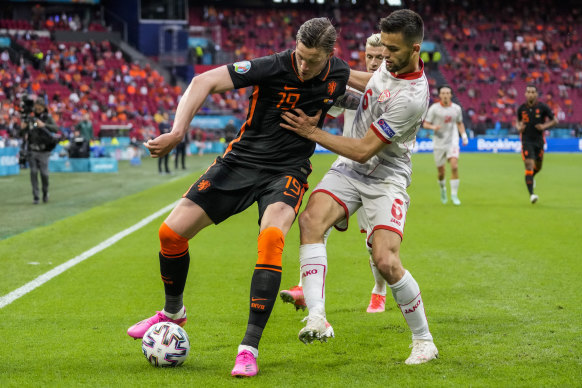 Wout Weghorst of the Netherlands, left, duels for the ball with North Macedonia’s Visar Musliu.
