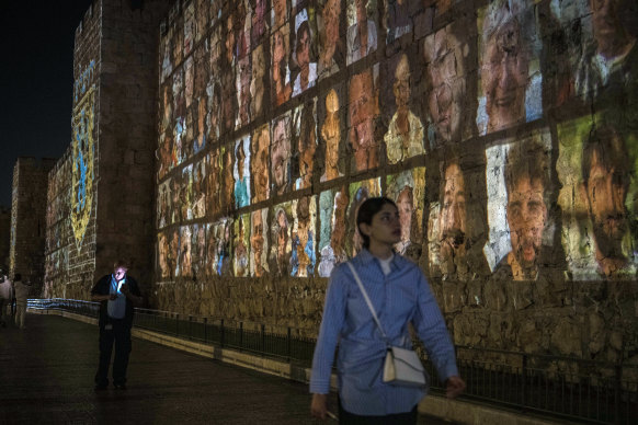 Images of those taken hostage by Hamas militants are projected on the outer wall of the Old City of Jerusalem.