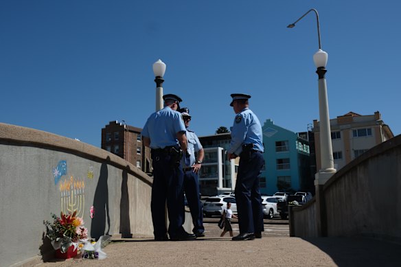 Police patrol the Bondi Beach footbridge after the terror attack. 