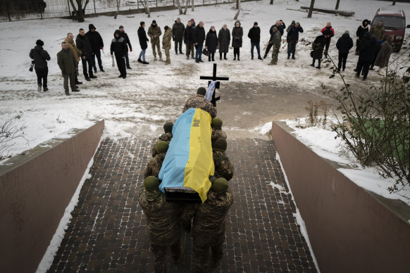 Ukrainian soldiers carry the coffin of a fallen comrade in Bucha in January.