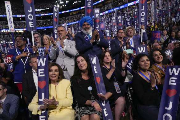 Nancy Pelosi and other delegates listening to President Joe Biden on day one of the DNC last week.