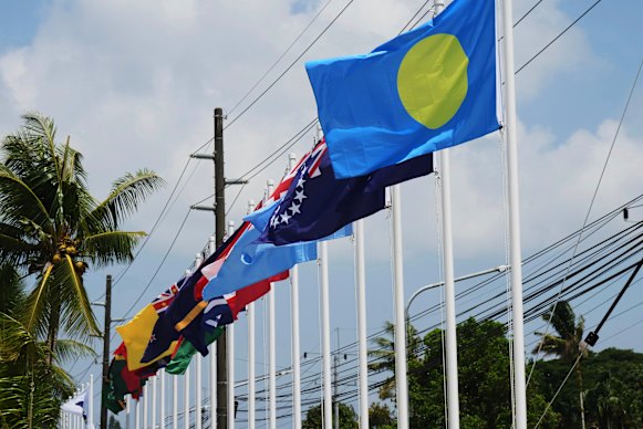 Flags of member states fly outside the summit venue for the Pacific Islands Forum Leaders Meeting in Koror, Palau.