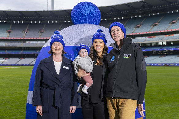 Neale Daniher (R) poses for a photograph with daughter Bec Daniher (C), granddaughter Billie Daniher and Fight MND CEO Dr Fiona McIntosh (L) during the FightMND Launch Of The Big Freeze 8 Campaign at Melbourne Cricket Ground.