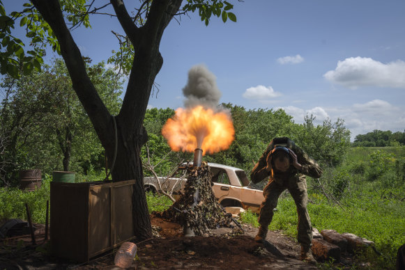 A Ukrainian soldier fires a mortar at Russian positions on the frontline near Bakhmut in late May.