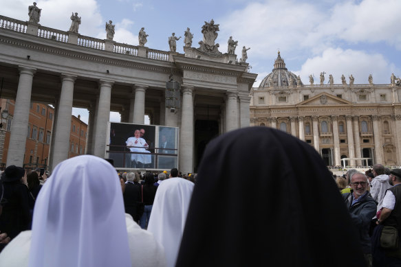 Nuns gathered in St Peter’s Square at the Vatican to see the pope on giant screens.