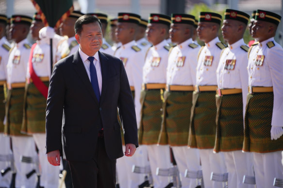 Cambodian Prime Minister Hun Manet inspects an honour guard during a visit to Malaysia on Tuesday. The prime minister’s family retain control of many senior roles in the Cambodian government. 