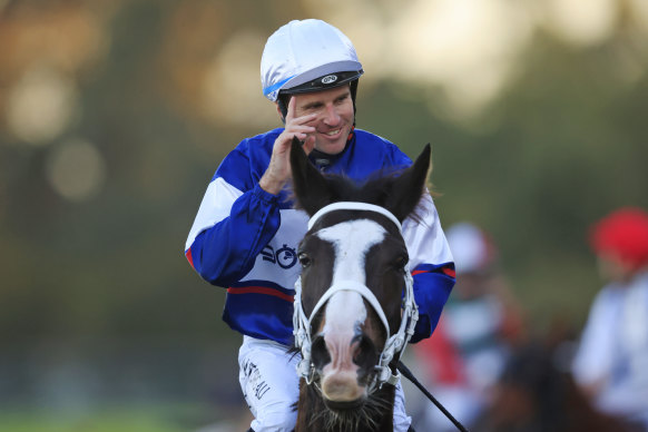Tommy Berry salutes after winning the last at Rosehill on Mubariz, his third winner for the day.