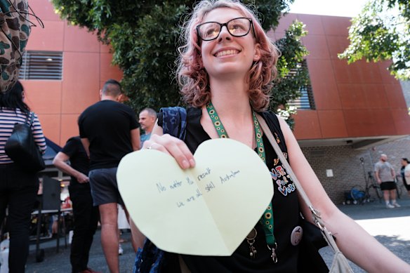 Nanushka handing out heart-shaped cards for voters to write a message of healing.