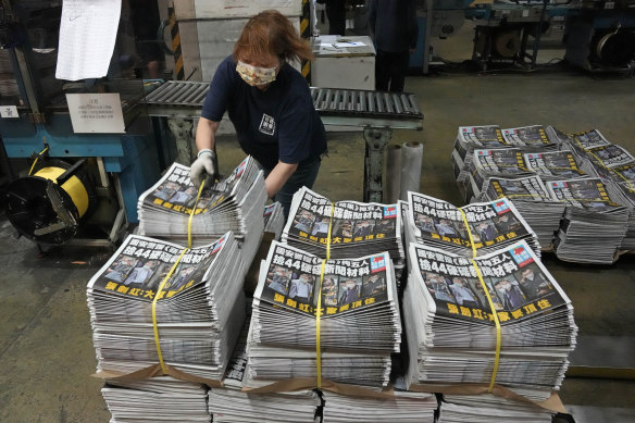 A worker packs copies of the Apple Daily newspaper at the printing house in Hong Kong.