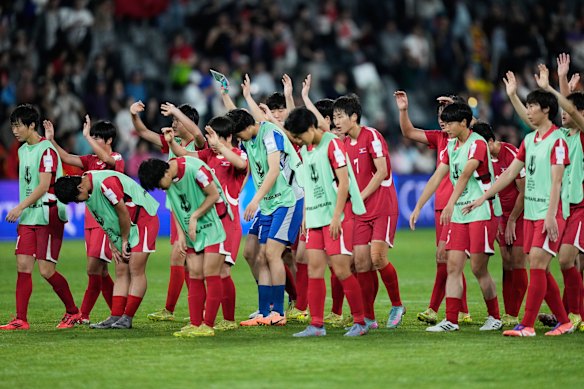 North Korea bows to their supporters following the Women’s Asian Cup soccer match between China and North Korea in Sydney.