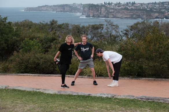 NSW Environment Minister James Griffin (centre), influencer Alex Hayes (left) and Paralympian Ben Tudhope are part of a relay team running the Bondi to Manly ultra-marathon.
