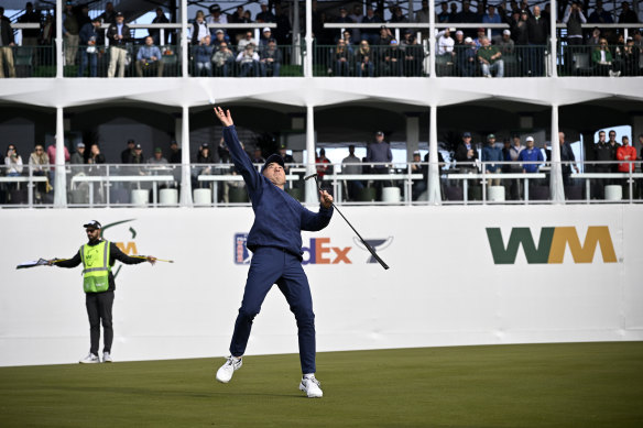 Doug Ghim of the United States tosses his ball to fans on the 16th green.