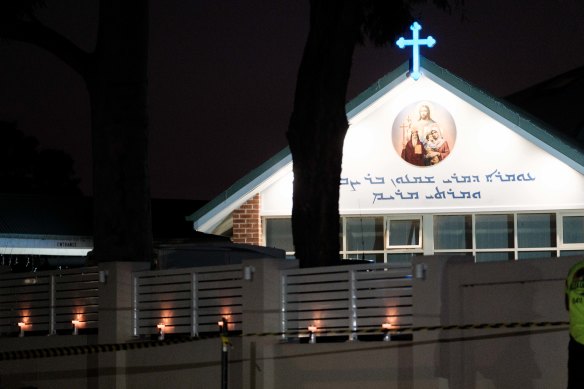 Candles line the fence of the Christ The Good Shepherd church in Wakeley.