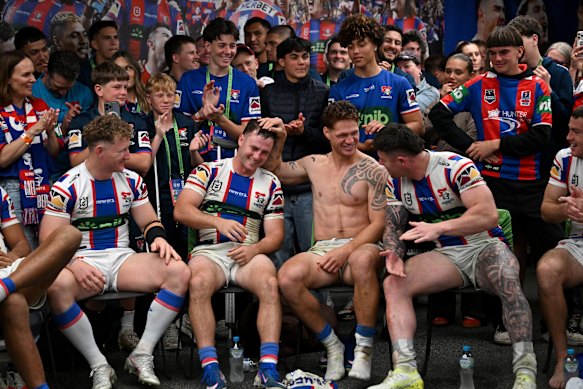 Sandon Smith and Knights teammates celebrate in the sheds after Sunday’s epic victory.