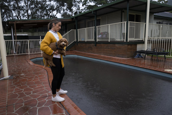 Kristy Lakeman next to her pool, which is still black with coal dust, at her Russell Vale home.