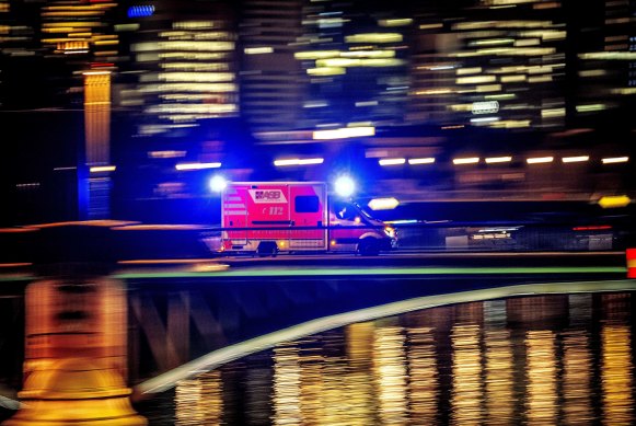 An ambulance speeds over a bridge in Frankfurt, Germany.