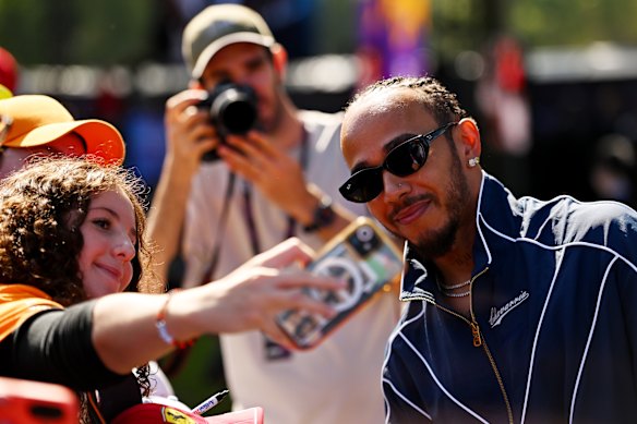 Lewis Hamilton poses for a selfie with a fan in Melbourne ahead of the F1 Grand Prix.