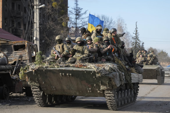 Ukrainian soldiers ride through the town of Trostsyanets. Putin underestimated the Ukrainian spirit.