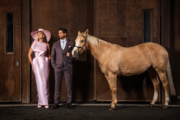 Racing fashion expert Laura Dundovic in Mariam Seddiq and Stacey Hemera millinery with ATC member Duncan James in MJ Bale with Tash at Royal Randwick.