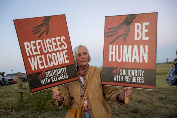 A woman protests against the Rwanda deportation flight at Boscombe Down Air Base in Wiltshire, England this week.