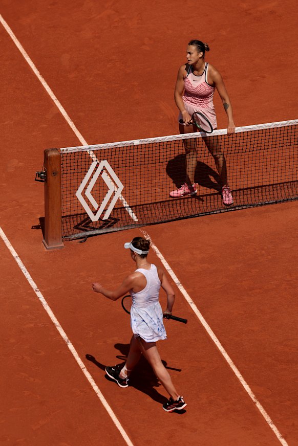 Belarusian Aryna Sabalenka waits at the net as Elina Svitolina of Ukraine refuses to shake hands.