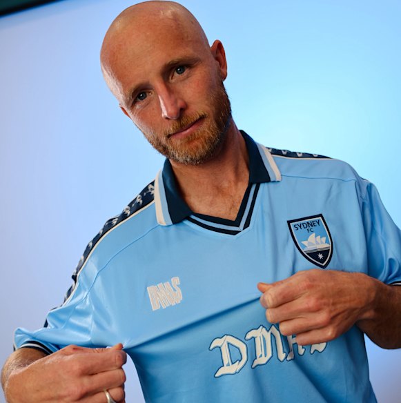 A merchandise collaboration between Australian band DMAs and A-League club Sydney FC, modelled by player Rhyan Grant in the style of a retro football jersey – despite both the band and team being founded years after the style of shirt was first introduced.