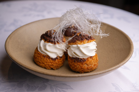 Black sesame choux and vanilla soft-serve sandwich is served as a trio.