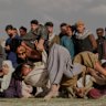 Afghans wrestlers fight during a match at the Chaman-e-Hozari Park in Kabul, Afghanistan.