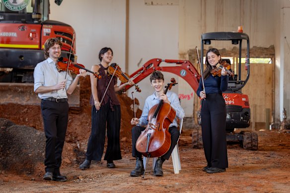 Jonah Spriggs, Hannah Tyrrell, James Monro and Mattea Osenk rehearsing among South Melbourne Town Hall redevelopment works.