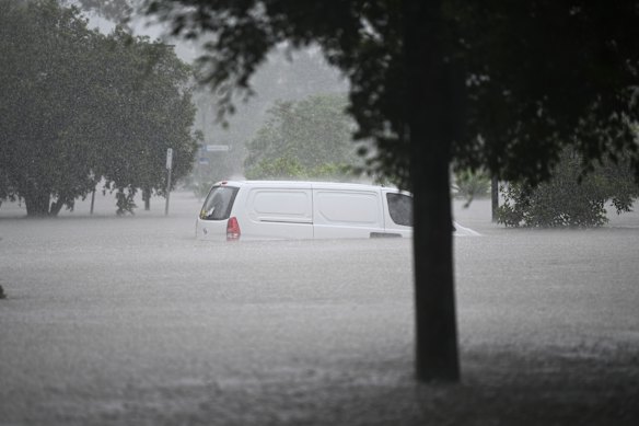A car is submerged at Stones Corner.