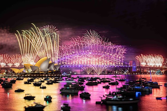 Fireworks explode from the Sydney Harbour Bridge and Opera House to welcome in the New Year. 