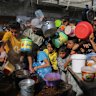 Palestinians crowded together as they wait for food distribution in Rafah, in the southern Gaza Strip. 