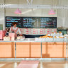 Staff at Baked Wonder in Burwood East wear frilly pink uniforms.