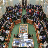 Queensland MPs standing to indicate their vote in favour of the Palaszczuk government’s voluntary assisted dying bill at the end of its second reading debate on Thursday.