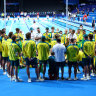 The Australian swim team huddle on pool deck in Paris.