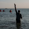 A man gestures as he waits to board a migrant dinghy to sail into the English Channel on June 17, 2025 in Gravelines, France. A record number of migrants have made the illegal crossing from France to the UK via small boats so far this year. Figures surpassed the 16,000 mark last week, which is 42% more than the same point last year.