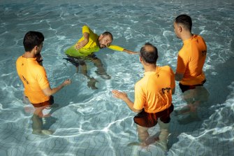 Ramzi Hussaini demonstrates key water safety skills to newly arrived refugees.