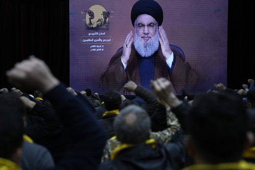 Supporters of the Iranian-backed Hezbollah group raise their fists and cheer, as they listen to a speech by Hassan Nasrallah.