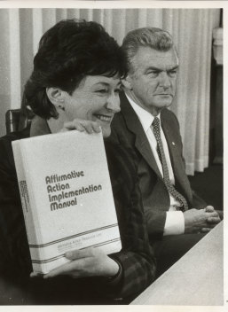Senator Susan Ryan with Prime Minister Bob Hawke as she holds the Affirmative Action Implementation Manual, June 1984.